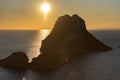 Stunning views of the sun falling behind Es Vedra with the Torre del Savinar in Es Vedra, Sant Josep de Sa Talaia, Ibiza, Spain.