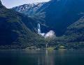 Stunning waterfall cascading down a lush hillside in Gaupne, Norway