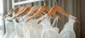 Stunning white bridal gowns on elegant hangers in a luxurious boutique bridal salon
