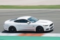 Stunning white Ford Mustang racing around on a competition track Royalty Free Stock Photo