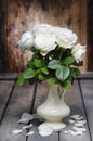 Stunning white roses in ceramic vase.