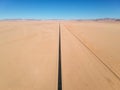 Stunning wide angle aerial drone view of the B4 desert road and a train line between LÃÂ¼deritz and Keetmanshoop