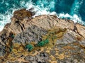 Stunning wide angle aerial drone view of the Mermaid Rock Pools and ocean waves at Matapouri Bay near Whangarei on the North Islan