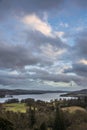 Stunning wide vista landscape view from Todd Crag in Lake District on a Winter evening with dramatic sky above