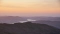 Stunning Winter dawn landscape view from Red Screes in Lake District looking South towards Windermere with colorful vibrant sky Royalty Free Stock Photo