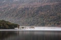 Stunning Winter foggy sunrise on Crummock Water in Lake District Royalty Free Stock Photo