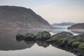 Stunning Winter foggy sunrise on Crummock Water in Lake District Royalty Free Stock Photo