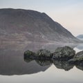Stunning Winter foggy sunrise on Crummock Water in Lake District Royalty Free Stock Photo