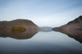 Stunning Winter foggy sunrise on Crummock Water in Lake District Royalty Free Stock Photo