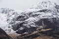 Stunning Winter landscape image of snowcapped Three Sisters mountain range in Glencoe Scottish Highands with dramatic sky Royalty Free Stock Photo