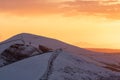 Stunning winter snowcapped mountain range hills summit sunrise. Mam Tor Derbyshire Peak District hill ridges hiking in winter snow