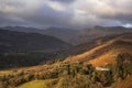 Stunning Winter sunrise golden hour landscape view from Loughrigg Fell across the countryside towards Langdale Pikes in the Lake Royalty Free Stock Photo