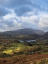 Stunning Winter sunrise golden hour landscape view from Loughrigg Fell across the countryside towards Langdale Pikes in the Lake Royalty Free Stock Photo