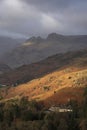 Stunning Winter sunrise golden hour landscape view from Loughrigg Fell across the countryside towards Langdale Pikes in the Lake Royalty Free Stock Photo