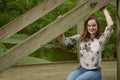 Beautiful young blonde woman poses in woods - spring fashion Royalty Free Stock Photo