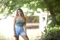 Stunning young brunette woman standing in shallow creek