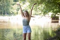 Stunning young brunette woman standing in shallow creek Royalty Free Stock Photo