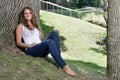 Stunning young Hispanic woman in jeans and tank top