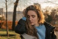 Stunning young woman with long wavy auburn hair. Portrait attractive beautiful model with brown wavy hair in the autumn park Royalty Free Stock Photo