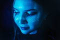 A stunning young woman with makeup adorned with stars radiates a beauty under the enchanting blue lights. Glamour, self-expression