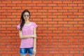 Stunning young woman posing outdoor over brick wall Royalty Free Stock Photo