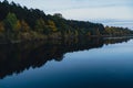 Stunningly beautiful lake in the golden autumn season. Magical multi-color reflection with light ripples on the surface Royalty Free Stock Photo