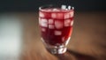 A Stunningly Realistic Shot Of A Glass Of Red Liquid With Ice Cubes