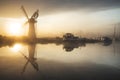 Stunnnig landscape of windmill and calm river at sunrise on Summ Royalty Free Stock Photo