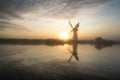 Stunnnig landscape of windmill and river at dawn on Summer morni Royalty Free Stock Photo