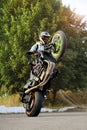 Stunt performer doing motorcycle tricks.