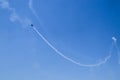 Stunt plane doing loops very blue sky with white smoke trail Royalty Free Stock Photo