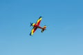 Stunt plane flying against clear blue sky. Royalty Free Stock Photo