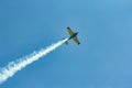 Stunt plane flying against clear blue sky. Royalty Free Stock Photo