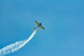 Stunt plane flying against clear blue sky. Royalty Free Stock Photo