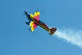 Stunt plane flying against clear blue sky. Royalty Free Stock Photo