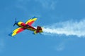 Stunt plane flying against clear blue sky. Royalty Free Stock Photo