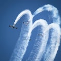 Stunt planes perform crowd pleasing stunts with smoke trails Royalty Free Stock Photo