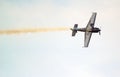 Stunt plane upside down with smoke trail. Royalty Free Stock Photo