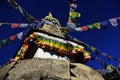 A stupa with eyes of Buddha and prayer flags in Nepalese Himalayas Royalty Free Stock Photo