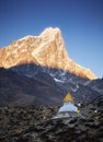 Stupa at sunrise near Dingboche village with prayer flags and mounts Kangtega and Thamserku, Nepal