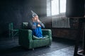 Stupid man in tinfoil helmet watch TV, UFO phobia Royalty Free Stock Photo