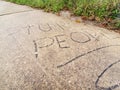 Stupid people carved into side walk