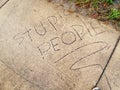 Stupid people carved into side walk