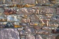 Sturdy beige and purple cut stone wall, seamless lined up