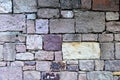 Sturdy beige and purple cut stone wall, seamless lined up