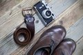 Sturdy brown boots, leather belt, and rangefinder camera