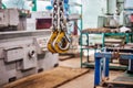 Industrial lifting device with chains and hooks in a spacious workshop for heavy load management Royalty Free Stock Photo