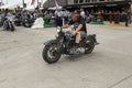 A byker riding his chopper motorcycle during the annual Sturgis Motorcycle rally in the main street of the city of Sturgis