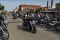 A byker riding his chopper motorcycle during the annual Sturgis Motorcycle rally in the main street of the city of Sturgis Royalty Free Stock Photo