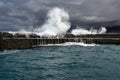 Storm on the Atlantic high waves wash over the harbor walls Royalty Free Stock Photo